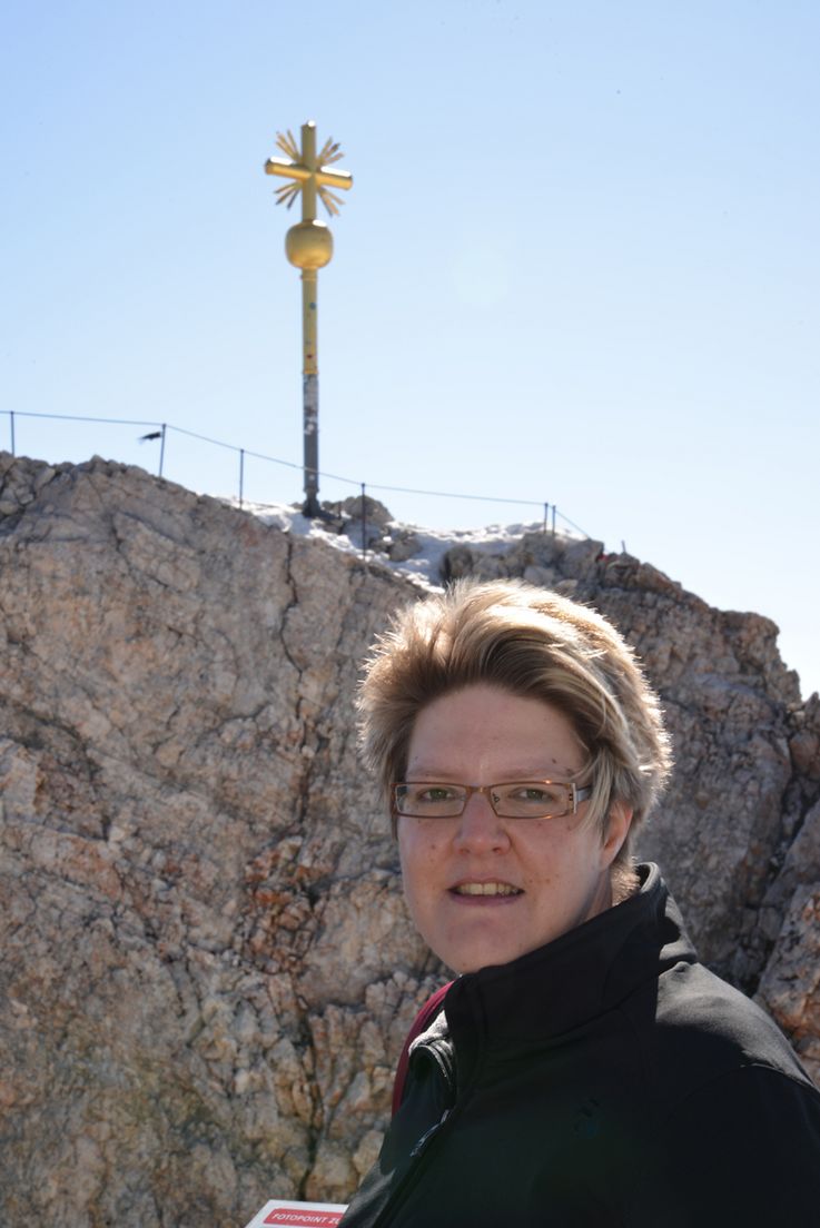 Kerstin Hürkamp vor dem Gipfelkreuz der Zugspitze. Bild: A. Unger
