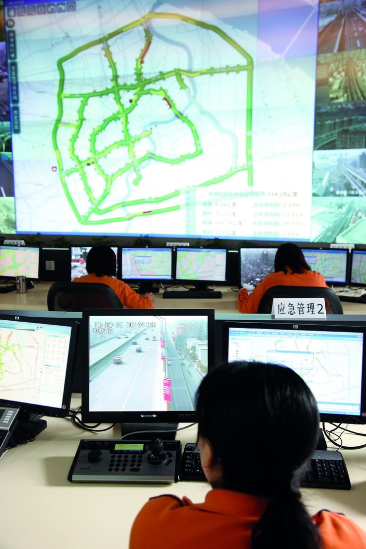 19 Mar 2010, Shanghai, China --- Employees monitor traffic conditions at the Digital Road Management Center in Shanghai, China on 19 March 2010. The government has invested heavily in road and mass transit projects in the past few years, and have implemented several emergency plans to ensure the smooth running of the upcoming 2010 World Expo. --- Image by © Qilai Shen/In Pictures/Corbis